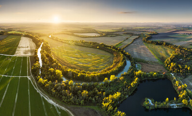 Wall Mural - Sunset at Danube river meandering through romantic Slovakia countryside nature landscape Near Senec from drone.