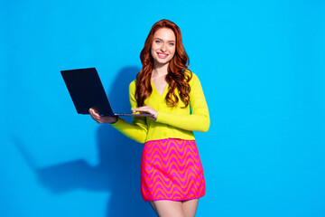 Wall Mural - Photo portrait of pretty young girl hold netbook wear trendy yellow outfit isolated on blue color background