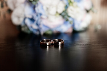 Poster - wedding gold rings on the table in the morning