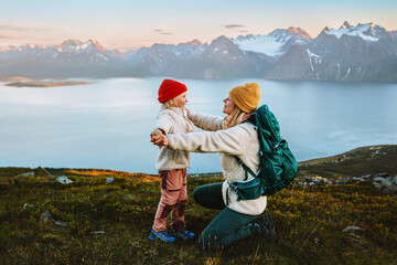 Wall Mural - child playing with mother family hike in mountains outdoor activity, travel together in norway healt