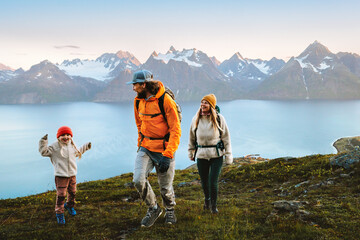 Wall Mural - family travelers hiking together - mother, father, and kid on active vacations in mountains of norwa