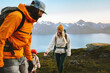 © EVERST - Family hiking together active travel lifestyle - mother, father, and child in mountains adventure tour in Norway, parents and kid on summer vacations outdoor, healthy lifestyle tourism, happy moments