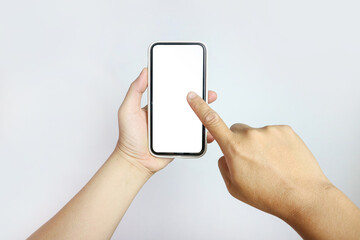 Hand holding a smartphone, and another hand pointing