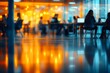 © Wannaeka - Modern office space with glass walls, people working on laptops, warm lighting, concrete floor, and professional atmosphere.