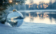 © Nim - Beautiful transparent thick glass ball for Christmas tree, lies on snow.