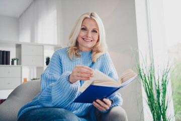 Wall Mural - Photo of pretty aged woman enjoy read book wear pullover free time modern apartment indoors