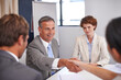 © Leffy/peopleimages.com - Business people, handshake and deal conversation with team management of partnership meeting. Shaking hands, communication and agreement at table with contract and operation review success in office