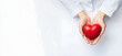 © john - Woman doctor hands holding red heart on wide white background donate for hospital care concept. Panoramic world heart day and world health day, CSR community, foster support patient. World heart day