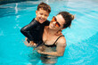 © kleberpicui - Happy Brazilian boy with his mother having fun in the swimming pool