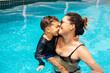 © kleberpicui - Happy Brazilian boy with his mother having fun in the swimming pool