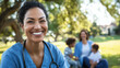 © Partha - A smiling healthcare worker in scrubs enjoying a well-deserved Labor Day break with family, outdoors in a park