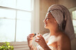 © Malambo/peopleimages.com - Woman, perfume and bathroom with relax, skincare and bottle for scent and fragrance at home. Calm, product and body mist with cosmetics spray and morning routine with grooming, smile and towel