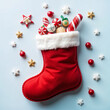 © Anastasiia Bublyk - Christmas santa boot with candies on white background. Christmas background.