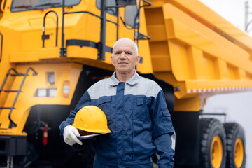 Portrait happy adult man industry worker with hardhat driver of mining truck