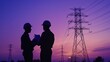 © ellisa_studio - Silhouettes of Engineers Discussing Plans Against a Sunset Sky