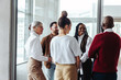 © Jacob Lund - Diverse business colleagues engaging in conversation during a conference in a modern office setting