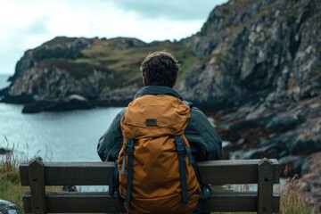 Poster - A person sitting on a bench with a backpack, great for travel or outdoor use