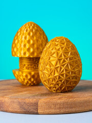 Close-up of a plastic egg model with ornament on a blue background