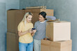 © Ilona - Two women are moving and call a logistics company to arrange the cargo.