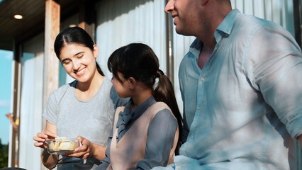 Lovely marriage couple and daughter picnic at outdoor terrace. Family using outdoor activity show love and care to strengthen good growth for child, strong family bond or relationship. Divergence.