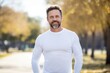 © Markus Schröder - Portrait of a content man in his 40s sporting a long-sleeved thermal undershirt over bright and cheerful park background
