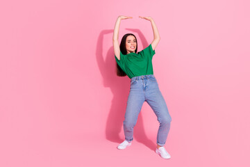 Poster - Full length photo of strong attractive lady dressed green t-shirt holding arms up empty space isolated pink color background