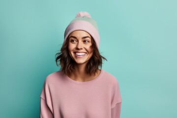 Poster - Portrait of a joyful woman in her 30s sporting a trendy beanie while standing against pastel or soft colors background