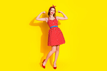 Wall Mural - Photo of lovely cute positive strong lady wear red trendy clothes isolated on yellow color background