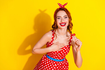 Wall Mural - Photo of positive adorable nice lady wear red trtendy summer clothes hold candy isolated on yellow color background