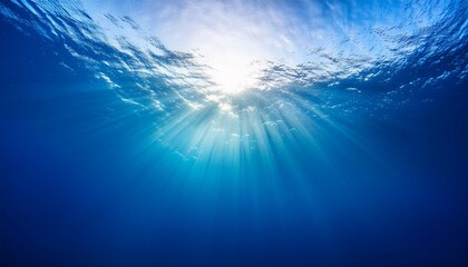 Wall Mural - sun shining light in blue clearly deep water sunbeams illuminate the blue underwater sea scene background