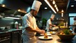 © jiwa - A chef in a white uniform prepares food in a professional kitchen