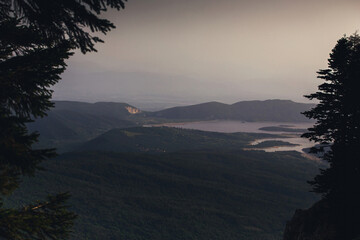 bird's eye view of mountain lake at sunset, winding lake among mountains