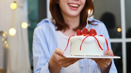 Beautiful Asian woman holding a strawberry cake. Asain Woman with Happy Birthday Celebrate party.