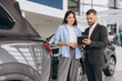 © anatoliycherkas - Young woman customer female buyer client wears shirt consult with salesman hold tablet choosing auto want to buy new automobile in car showroom vehicle salon dealership store motor show.