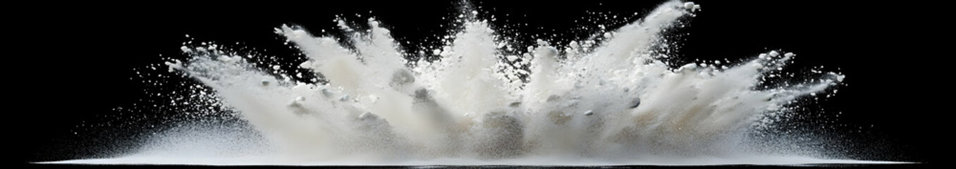 An explosion of white powder creating a dramatic visual effect against a dark background.