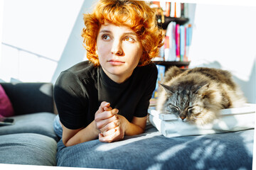 portrait red-haired attractive young woman with fluffy big cat