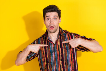 Canvas Print - Portrait of nice young man point fingers himself wear shirt isolated on yellow color background