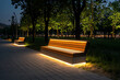 © Jiraphat.N - Illuminated benches in urban nighttime park