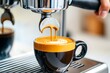 © Thanyarat - Barista pouring coffee from an espresso machine, with crema forming on top