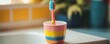 © jambulart - Toothbrush stands in colorful cup.