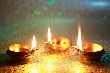 Wall Mural - Diwali celebration. Diya lamps on color background