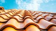 © Orxan - Close-up of an orange clay tile roof with a blue sky background, designed for banner use and ample space for copy