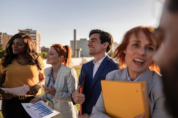 Group of business people having a lively discussion outdoors