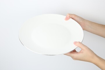 Canvas Print - Woman with empty ceramic plate on white background, closeup