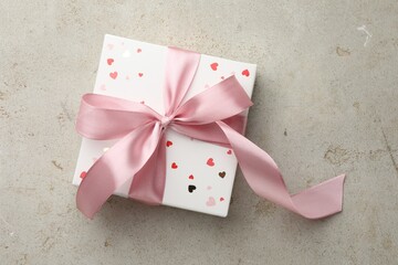 Sticker - Beautiful gift box with pink ribbon on light grey table, top view