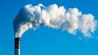 © Leli - The smokestack emits white smoke contrasting sharply with the blue sky