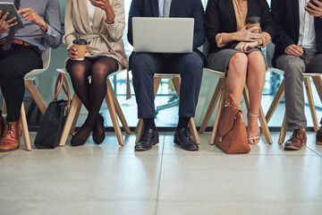 Wall Mural - Business people, legs and waiting room with row for job search, career opportunity or line at office. Group, employees or chairs with laptop, tablet or phone for technology or company offer together