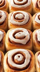 Warm cinnamon rolls sit invitingly in a dish, drizzled with creamy icing, creating a delicious breakfast treat perfect for sharing with friends and family