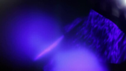 Wall Mural - abstract light leaks with blurred bright streaks and soft glow on dark background.