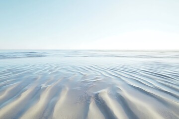 Wall Mural - The ocean tide receding over a smooth sandy beach leaving intricate patterns in the wet sand under a clear sky